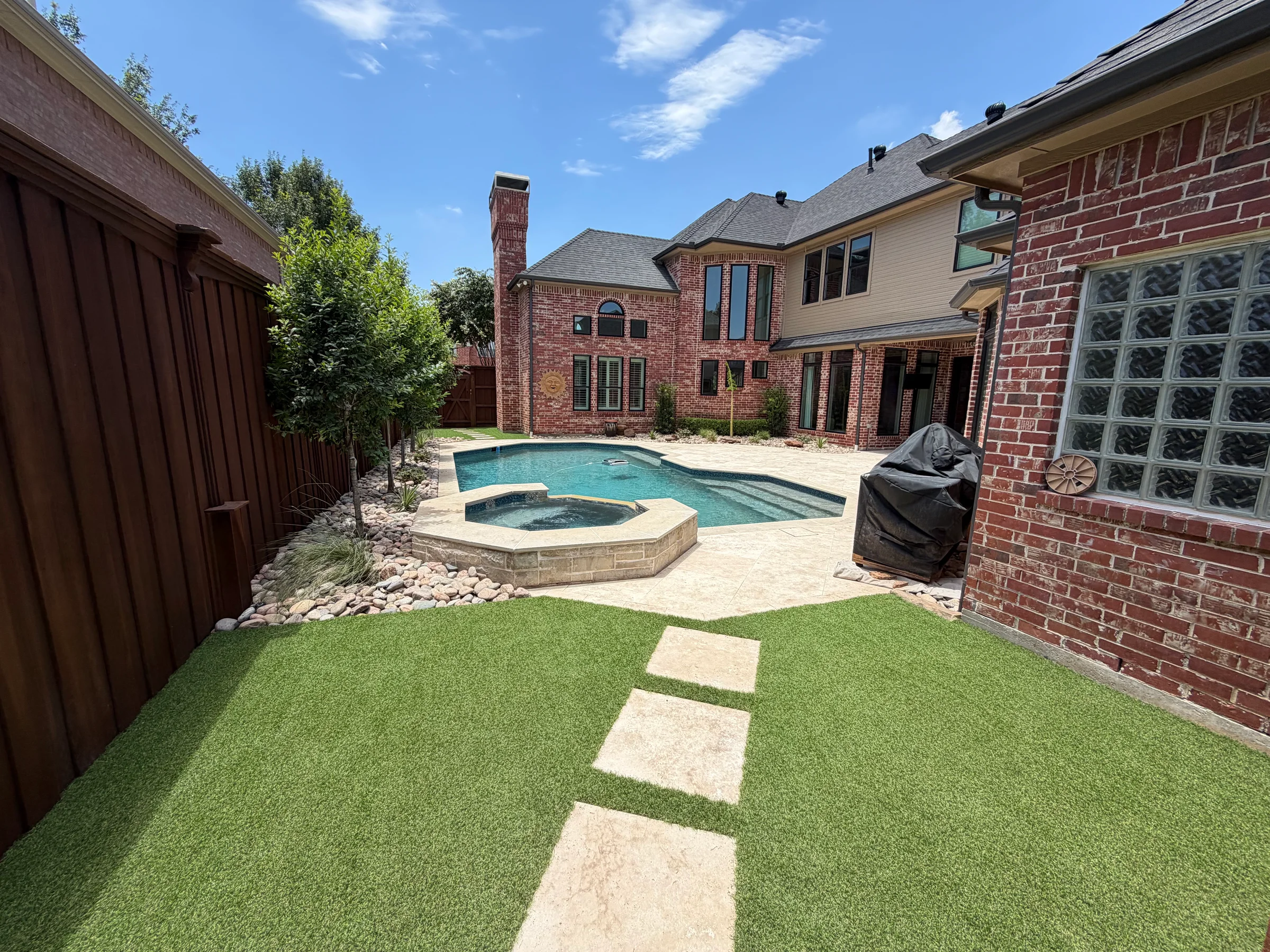 Poolside artificial turf, stepping stones, and hardscape