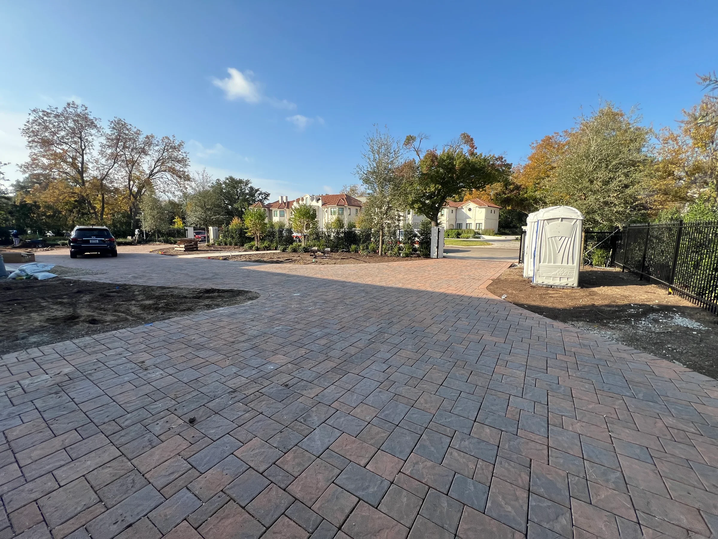 Completed residential interlocking paver driveway and paved entry area