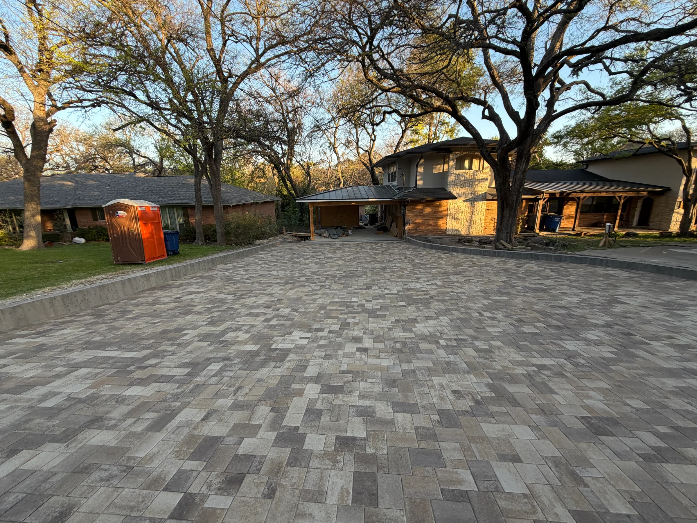 Completed large-format paver driveway or courtyard in front of a residential property