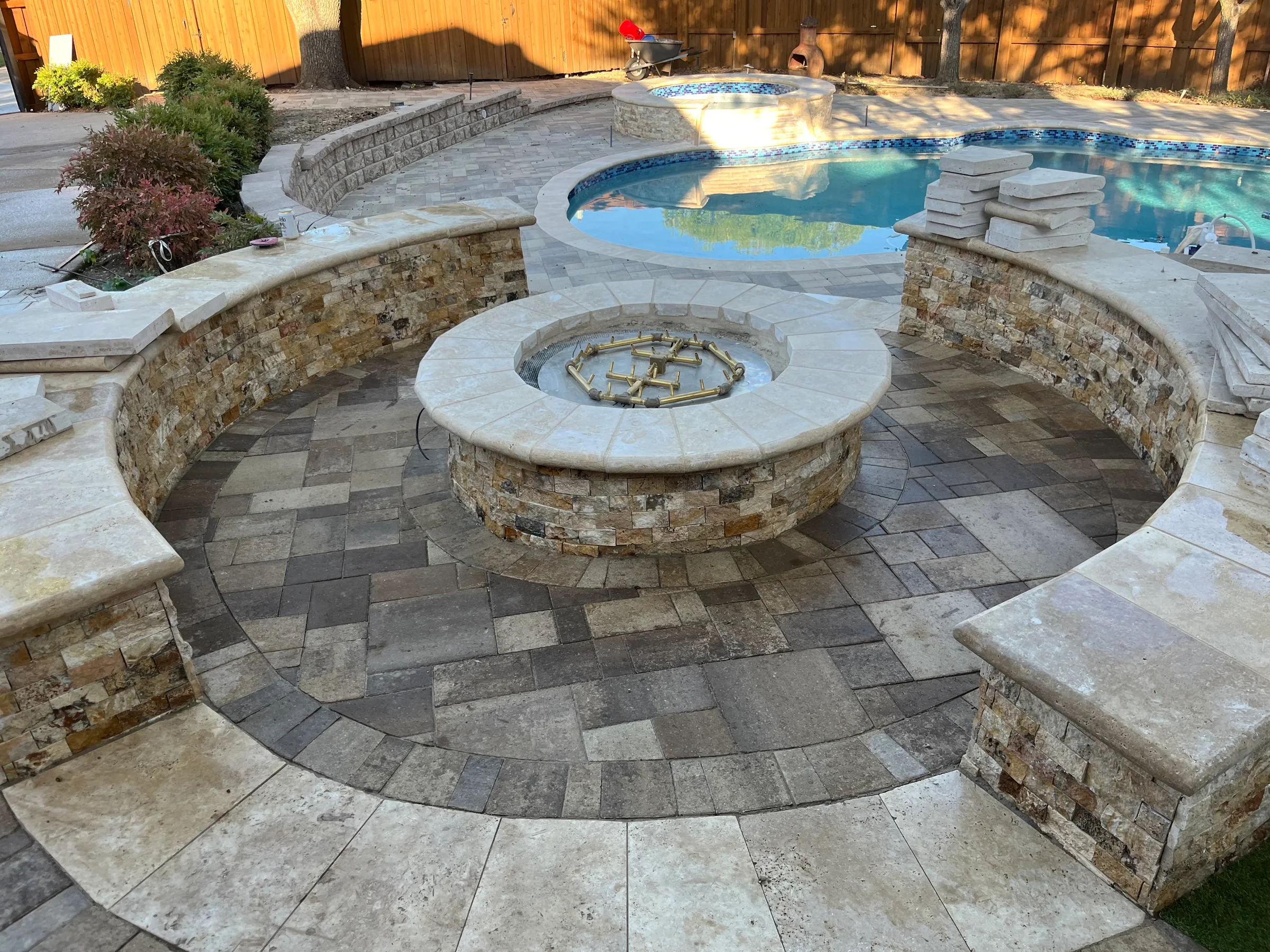 Paver patio, seat walls, and poolside fire pit