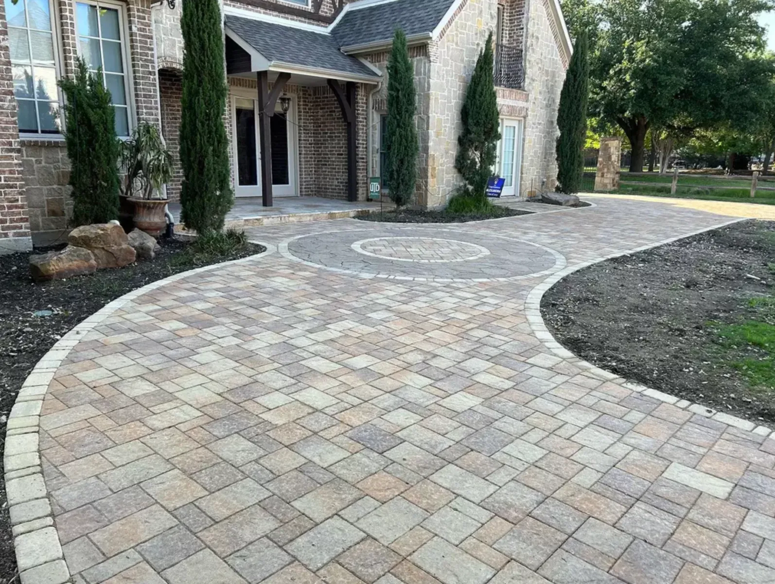 Circular paver driveway entry with a contrasting round medallion