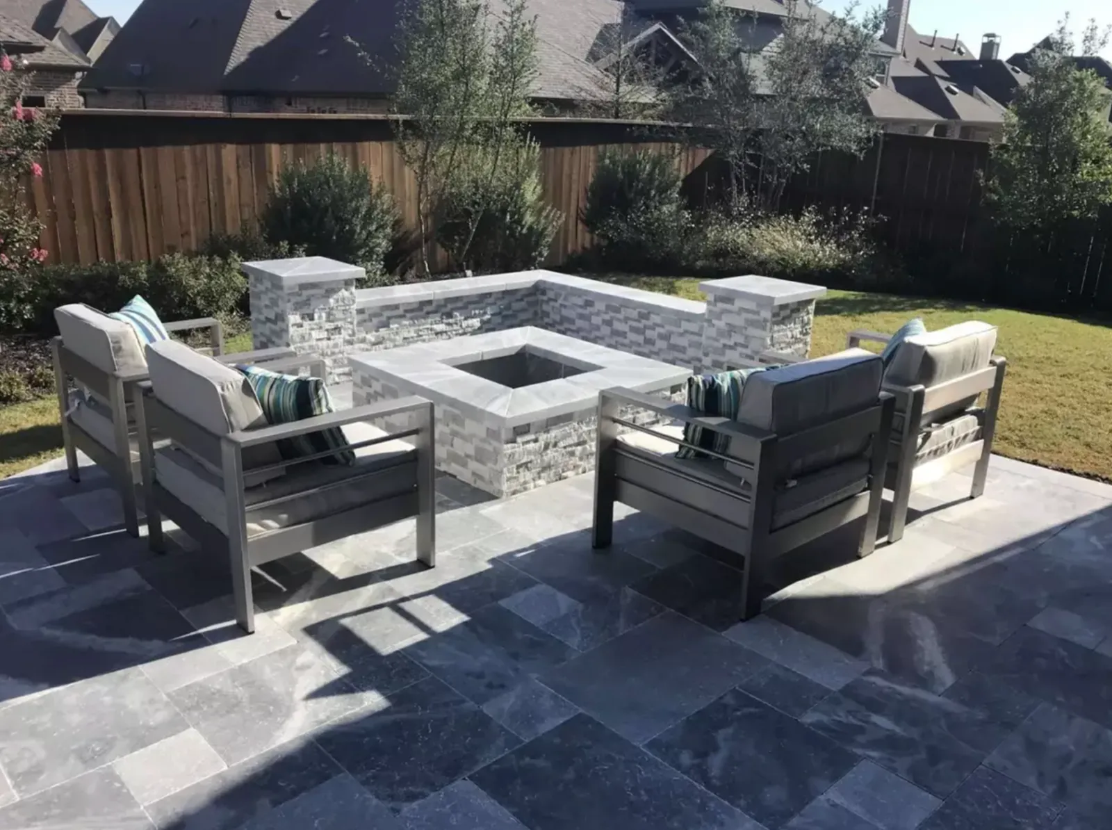 Sunken square fire pit patio with built-in stone seat walls