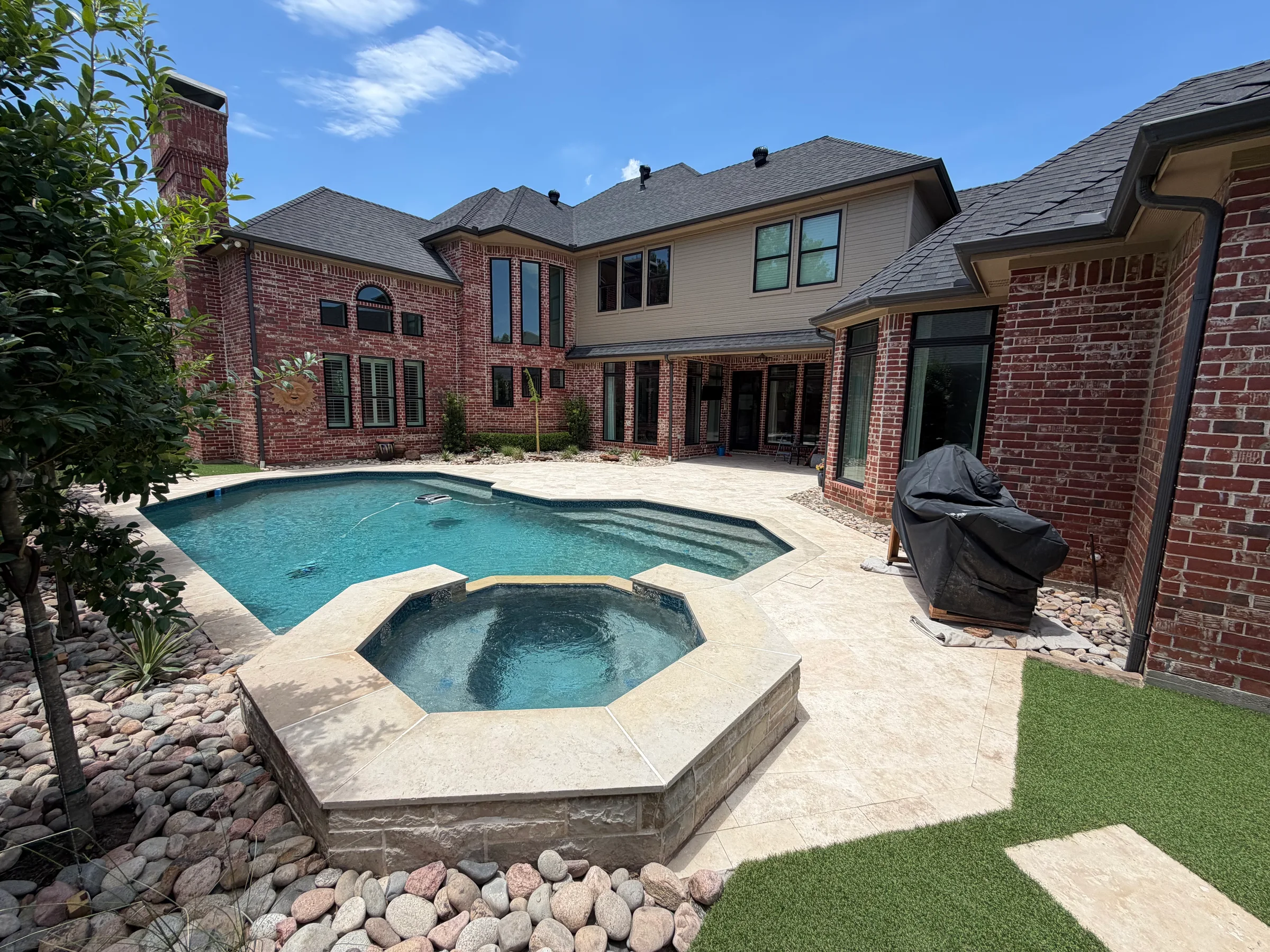 Pool and raised spa with light paver deck